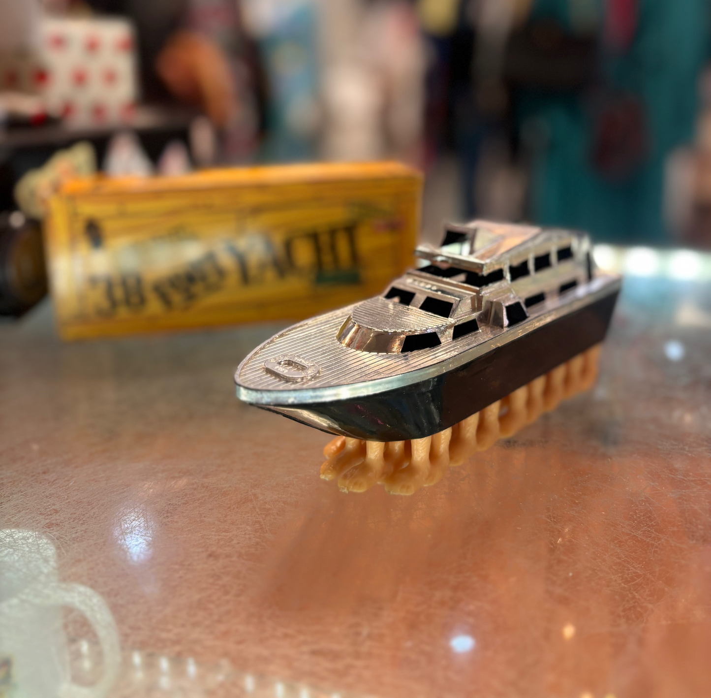 Model ship on a glass surface with a blurred background
