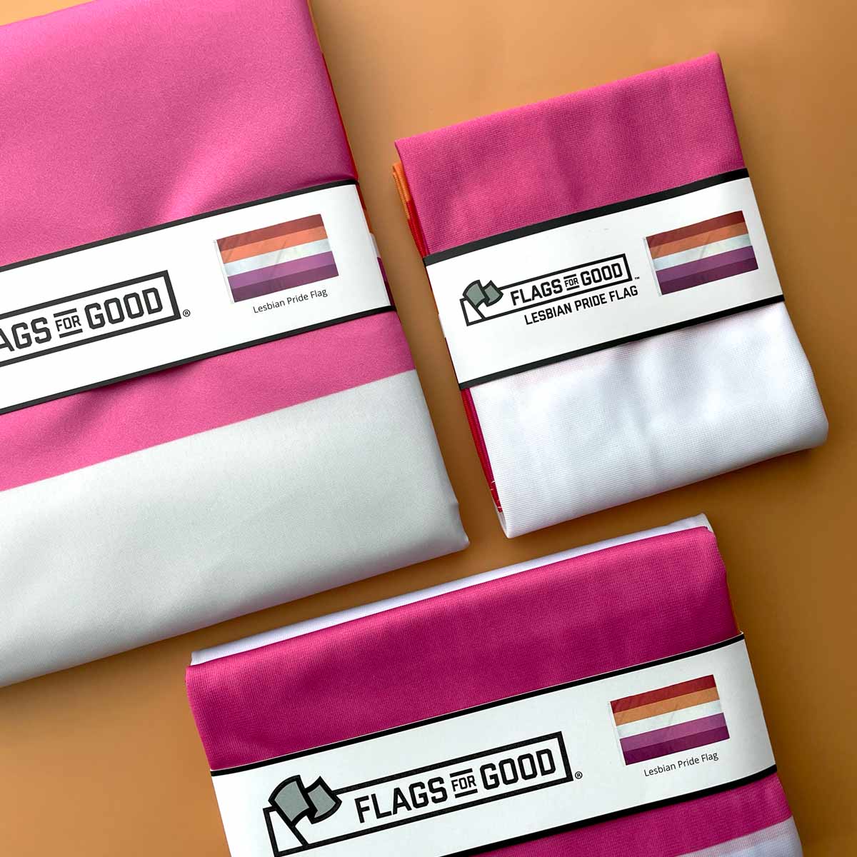 Three fabric swatches with lesbian pride flag design on 'Flags for Good' packaging.