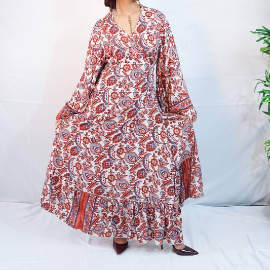 Long patterned dress with red and white design on a white background