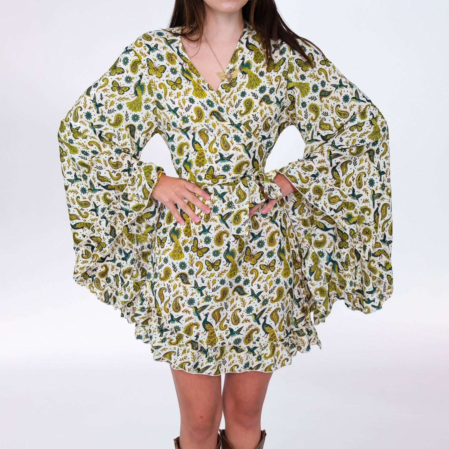 Woman wearing a floral patterned dress on a white background