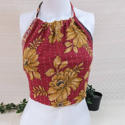 Red and yellow floral patterned top on a mannequin against a light background