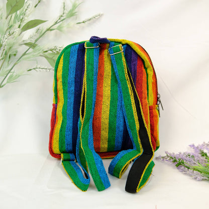 Colorful striped backpack on a white background with greenery
