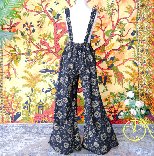 Floral-patterned overalls on a mannequin against a colorful tapestry background