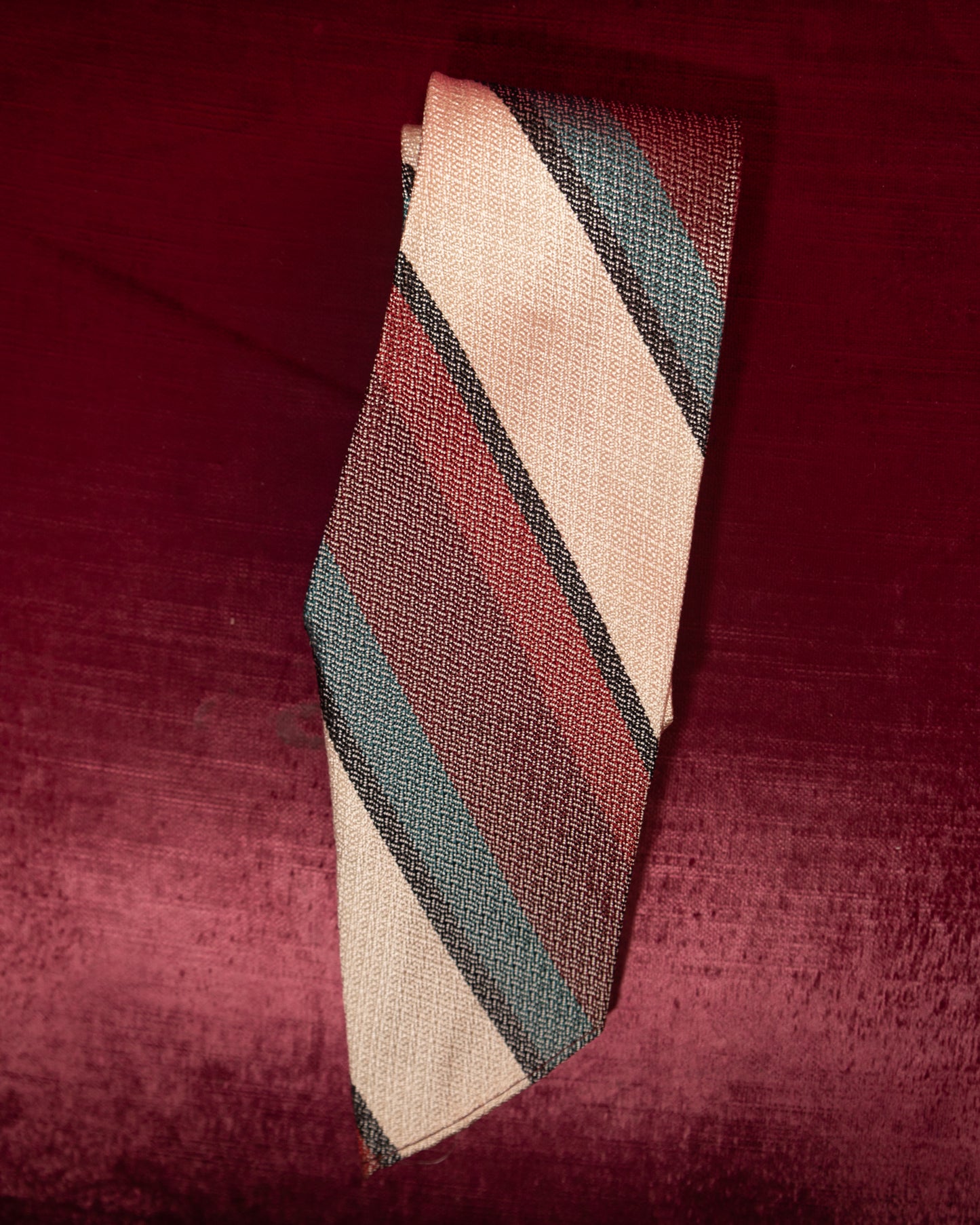 Striped tie on a textured red background