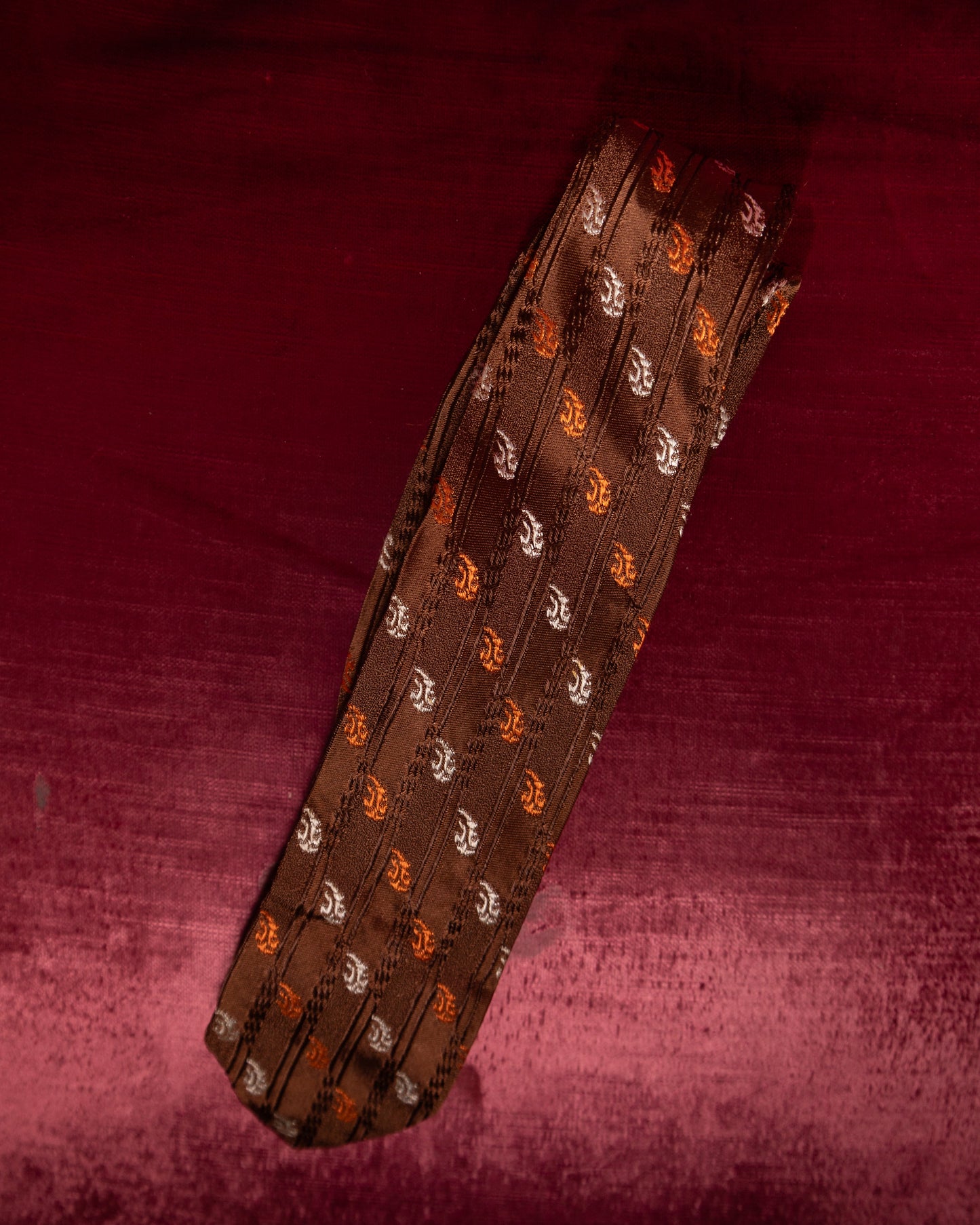 Patterned tie on a textured red background