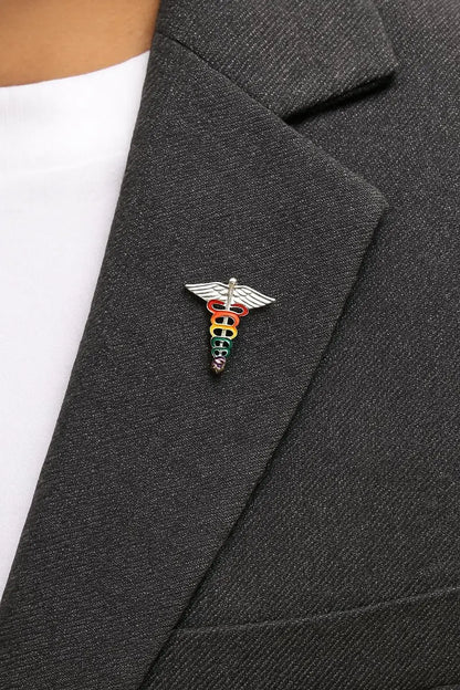 Rainbow medical symbol pin on a dark gray blazer