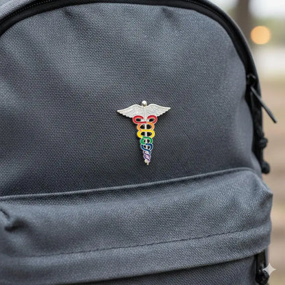 Gray backpack with a rainbow medical symbol pin on a blurred background