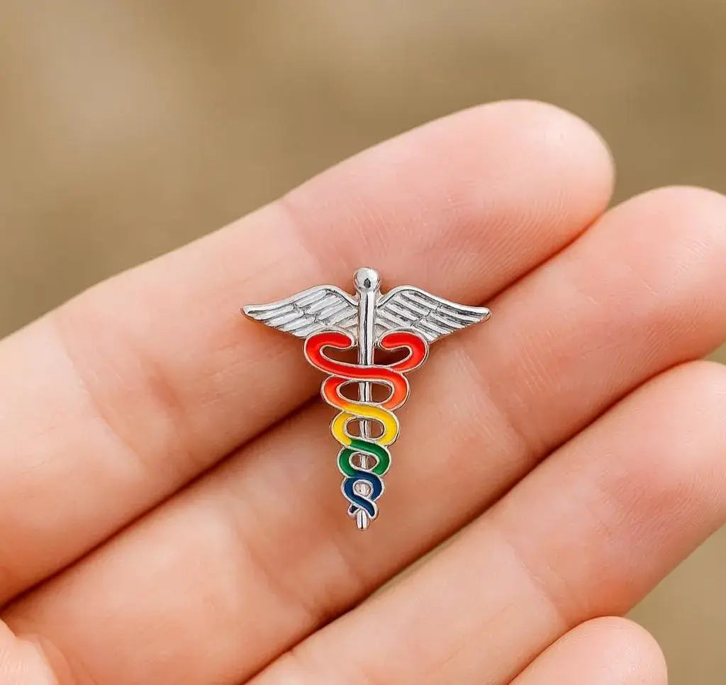 Colorful caduceus symbol on a hand with a blurred background