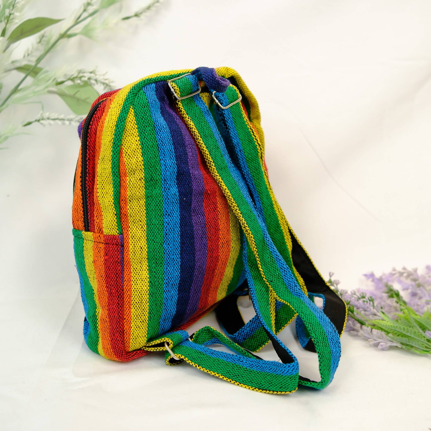 Colorful striped backpack on a white background with lavender flowers