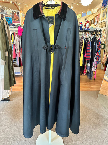 Vintage naval boat cloak with a yellow satin interior, black satin exterior, and a velvet collar, displayed on a mannequin.