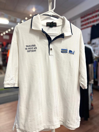 White polo shirt with text and logo on a hanger in a store setting