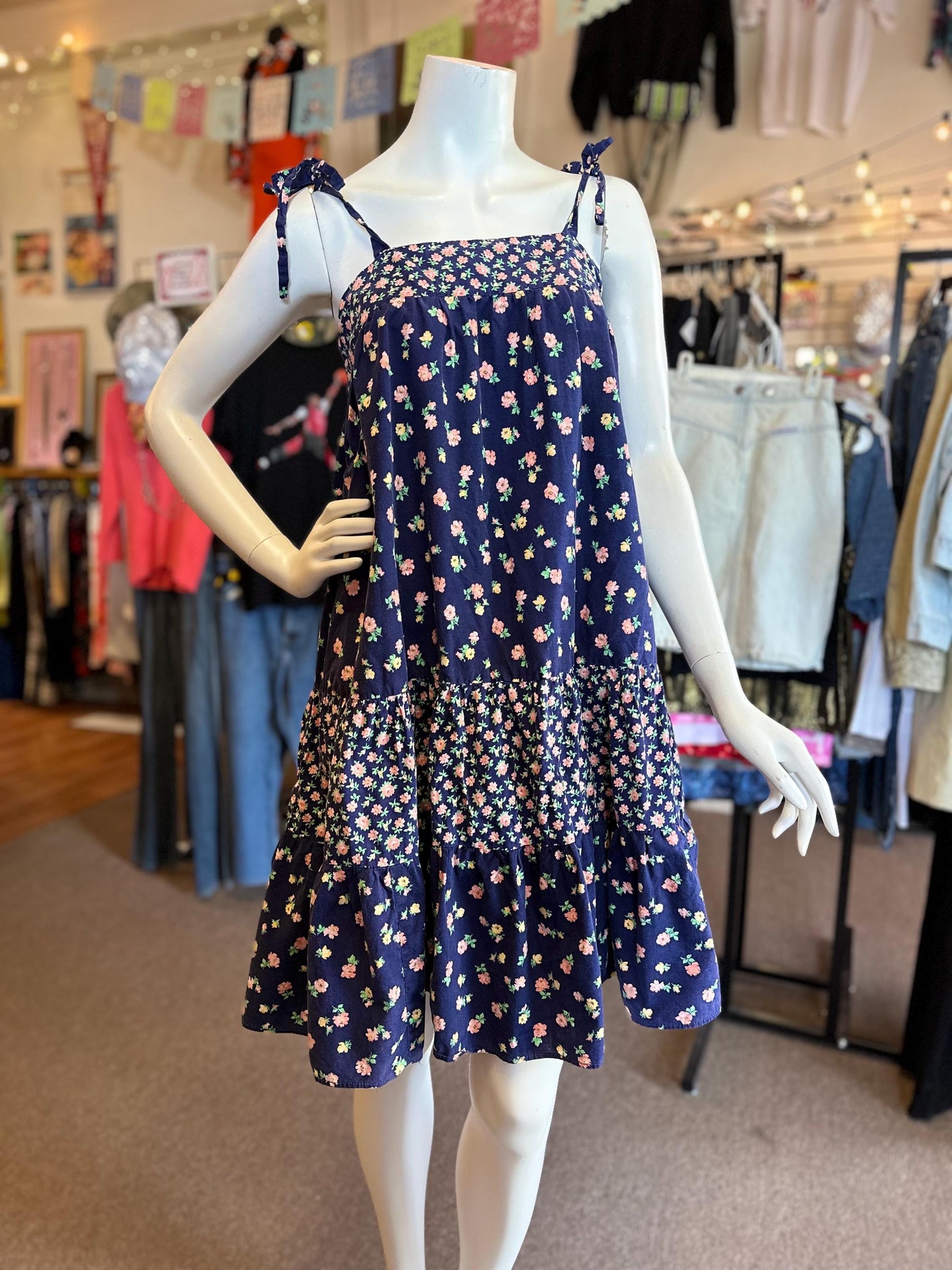 Navy floral dress on a mannequin in a clothing store