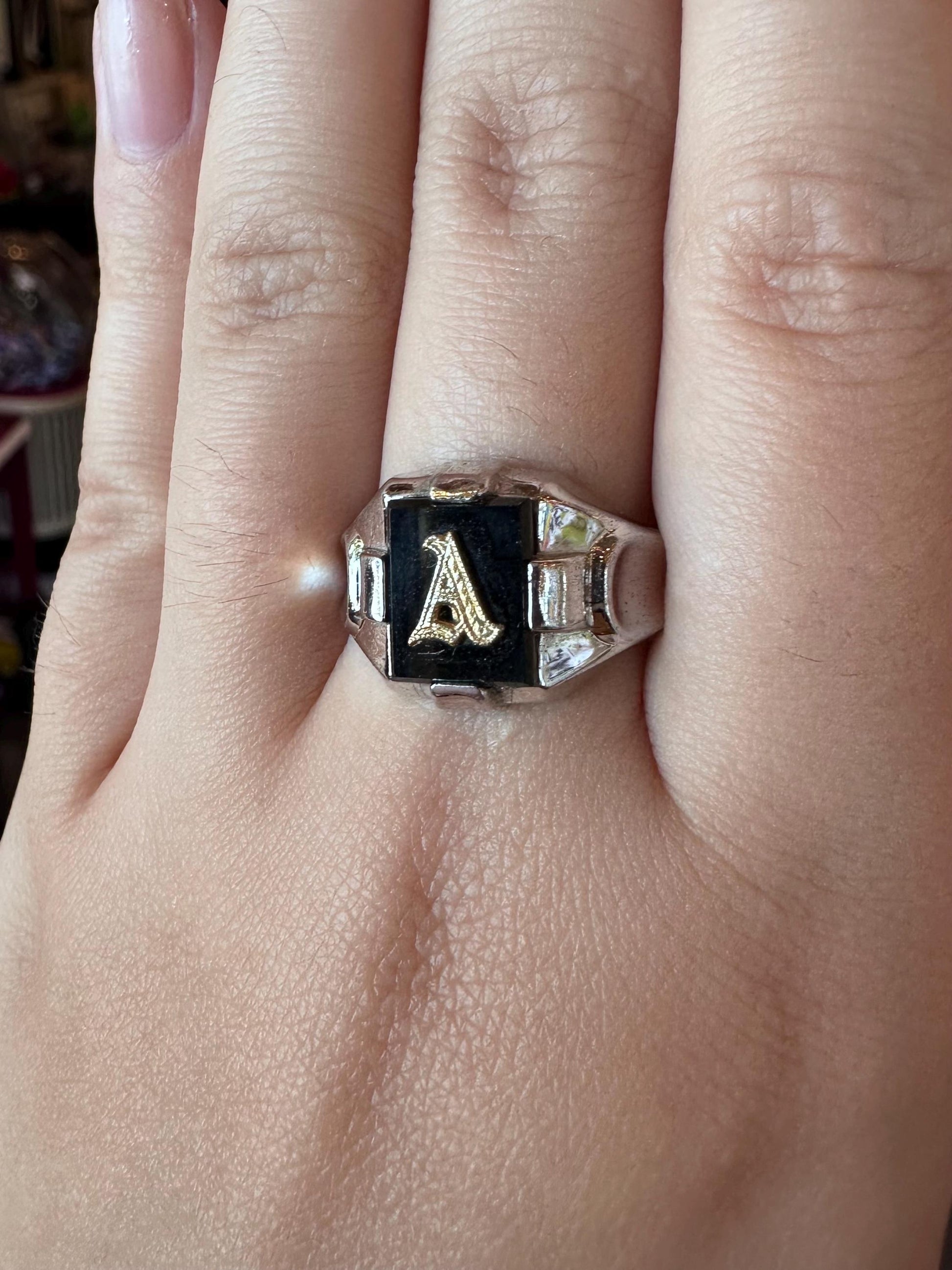 Ring with letter 'A' on a finger